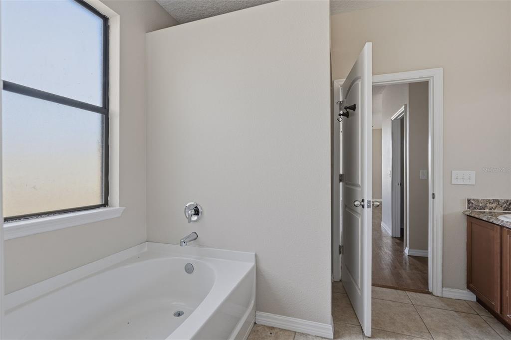 2318 Sebago Drive Lakeland, FL 33805 - Photo 21 of 54 a white bath tub sitting next to a white sink