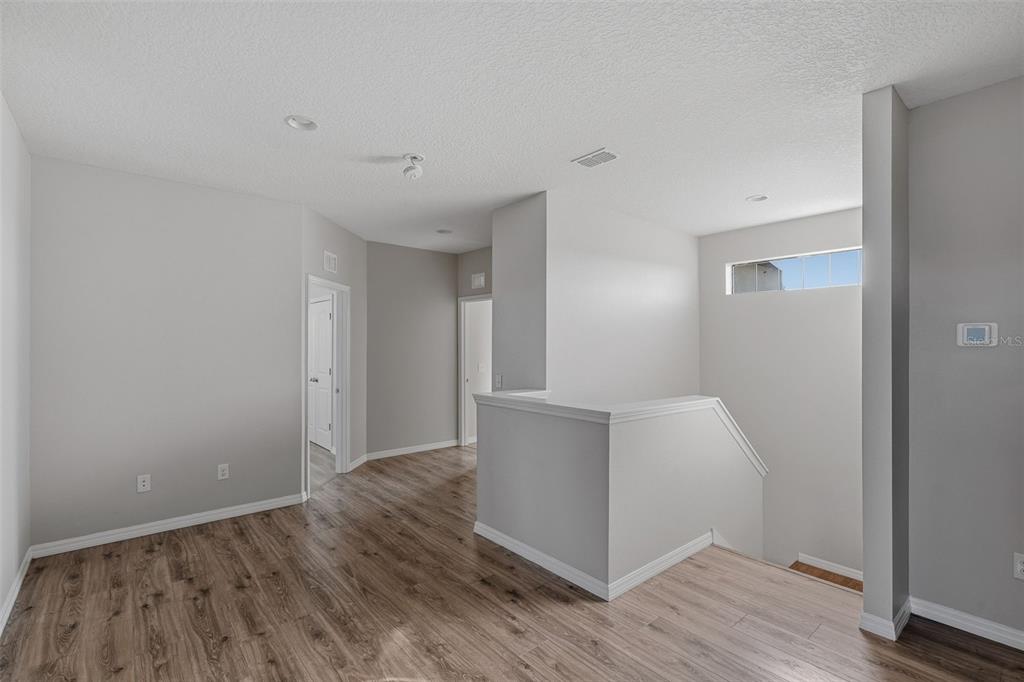 2318 Sebago Drive Lakeland, FL 33805 - Photo 25 of 54 an empty room with wooden floor and entrance