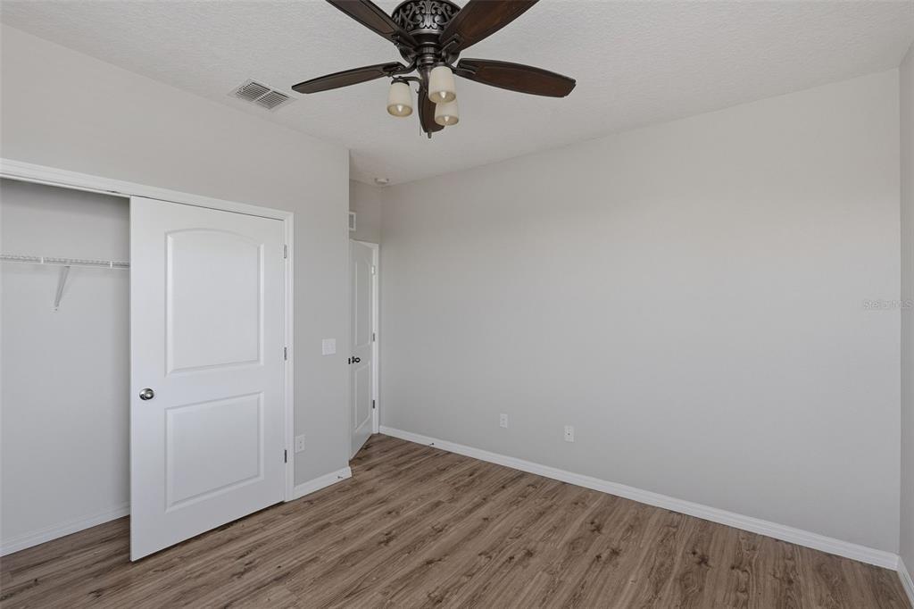 2318 Sebago Drive Lakeland, FL 33805 - Photo 32 of 54 a view of an empty room with wooden floor
