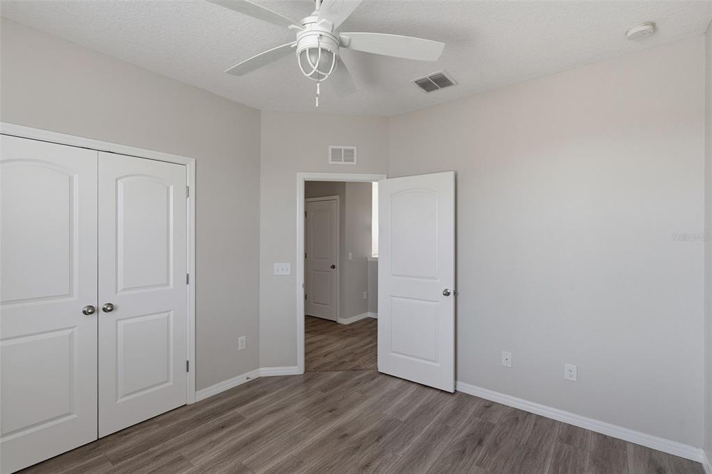 2318 Sebago Drive Lakeland, FL 33805 - Photo 34 of 54 wooden floor in an empty room with a window