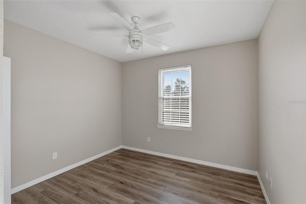 2318 Sebago Drive Lakeland, FL 33805 - Photo 35 of 54 a view of an empty room with wooden floor and a window