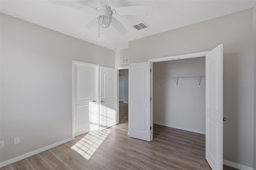 2318 Sebago Drive Lakeland, FL 33805 - Photo 36 of 54 a view of an empty room with wooden floor