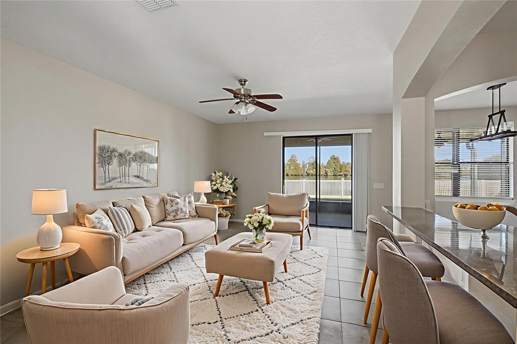 2318 Sebago Drive Lakeland, FL 33805 - Photo 7 of 54 a living room with furniture a chandelier and a large window