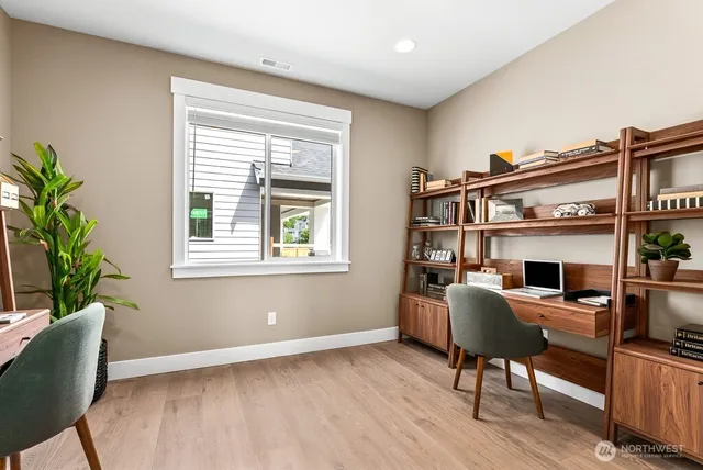 a workspace with furniture bookshelf and a window