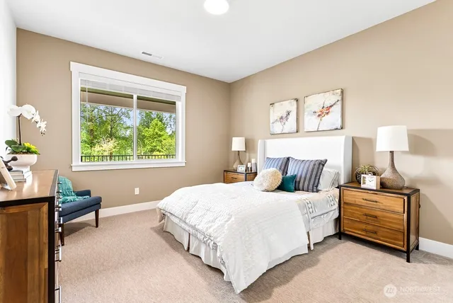 a bedroom with a bed dresser and a window