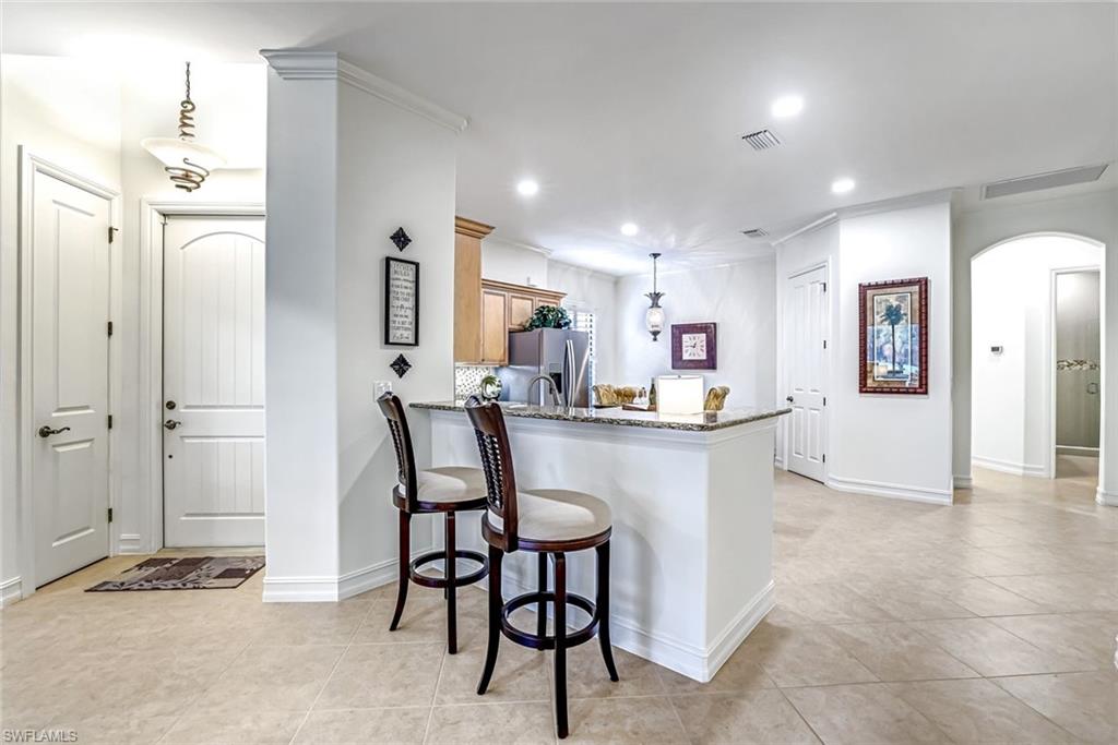 7523 Moorgate Point Way Naples, FL 34113 - Photo 13 of 32 Breakfast bar or handy space for serving snacks & beverages!