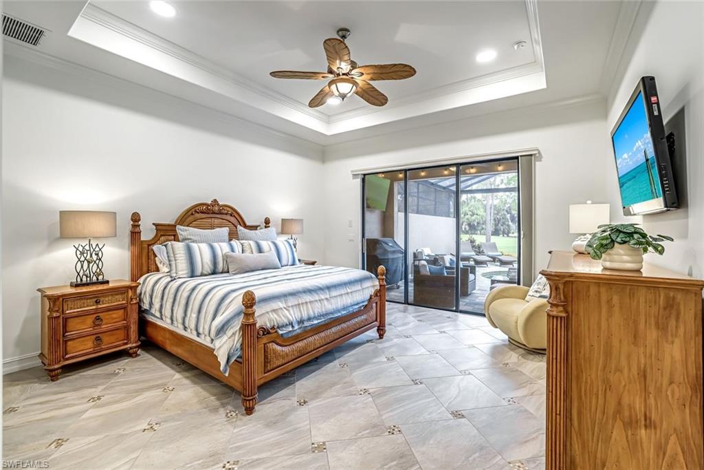 7523 Moorgate Point Way Naples, FL 34113 - Photo 17 of 32 Primary bedroom with view to lanai and golf course