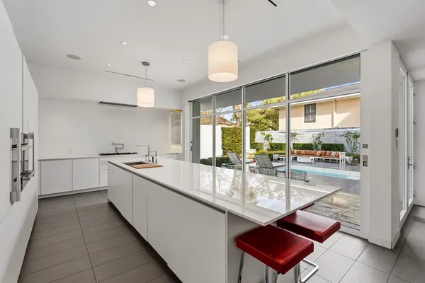 a large kitchen with kitchen island a large counter space and stainless steel appliances