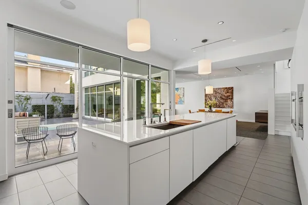 a large white kitchen with a large window