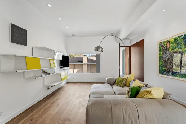 a bedroom with a bed couch and window