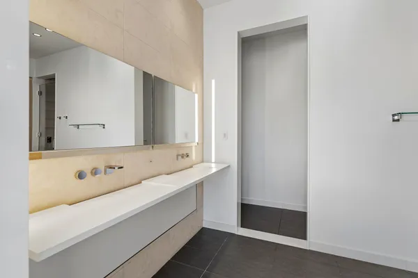 a bathroom with a double vanity sink and mirror