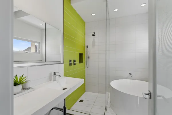 a bathroom with a bathtub a sink and a mirror