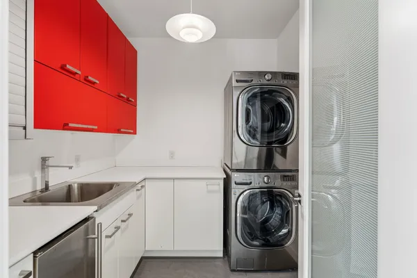 a utility room with sink dryer and washer
