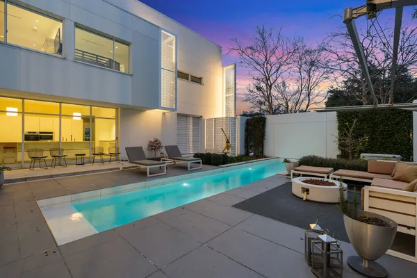 a view of a patio with a table chairs and a fire pit