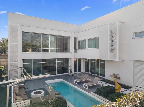 a view of a house with swimming pool and sitting area