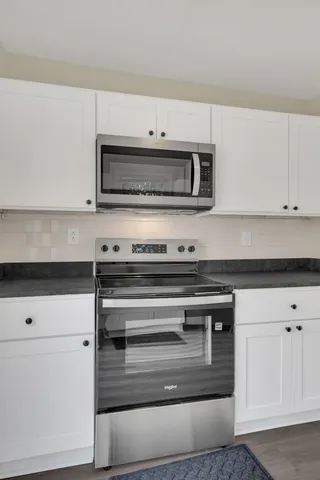 a stove top oven sitting inside of a kitchen