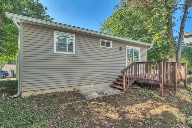 a view of a house with a backyard