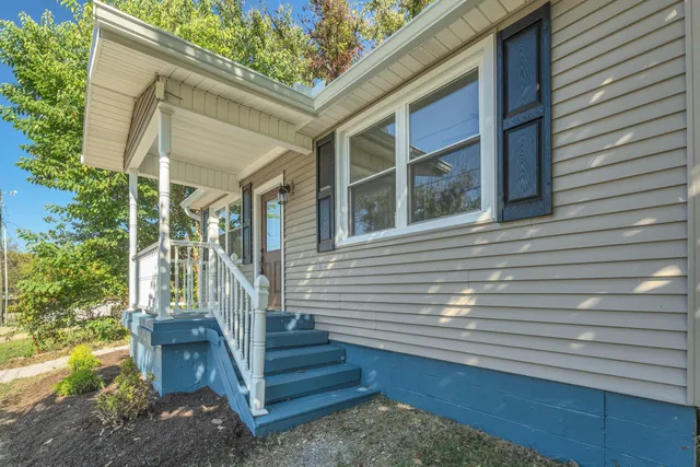 a view of a house with a window and stairs
