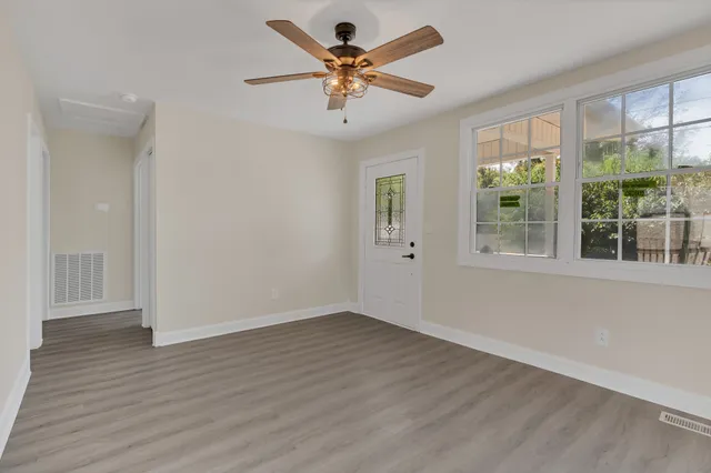 wooden floor in an empty room with a window