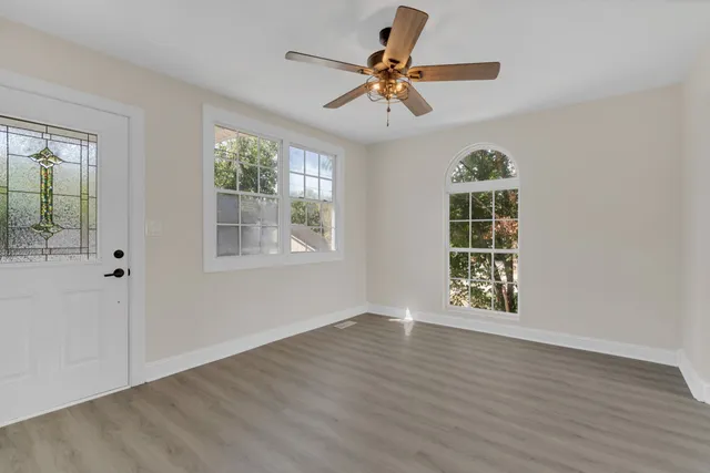 wooden floor in an empty room with a window