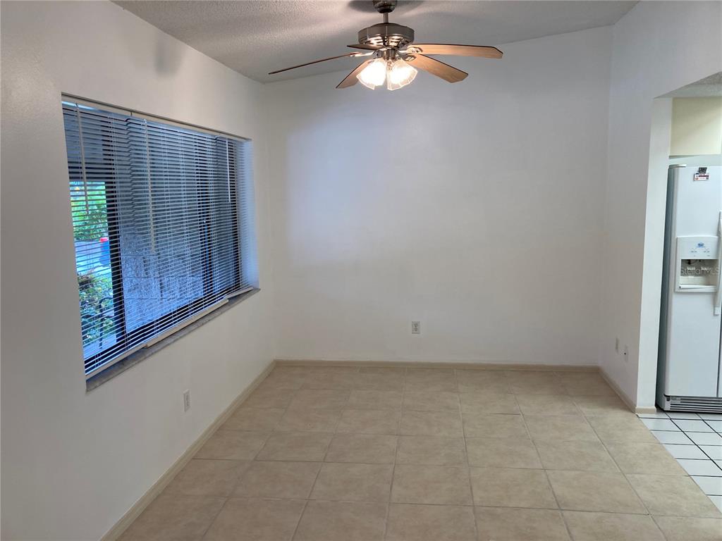 9000 Griggs Road, Unit C Englewood, FL 34224 - Photo 3 of 10 an empty room with windows and fan
