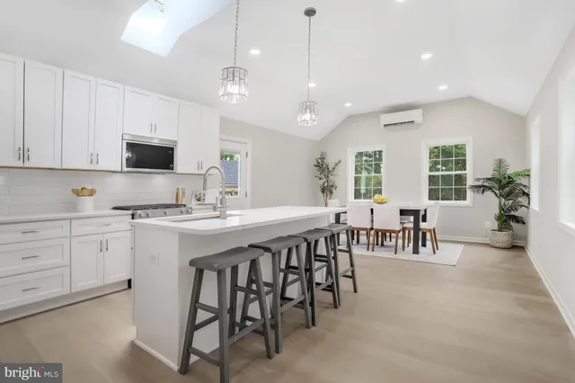 a large kitchen with a table and chairs