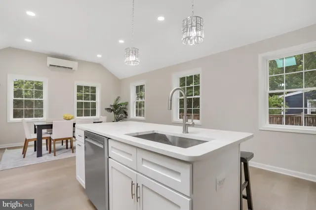 a kitchen that has a sink and a stove in it
