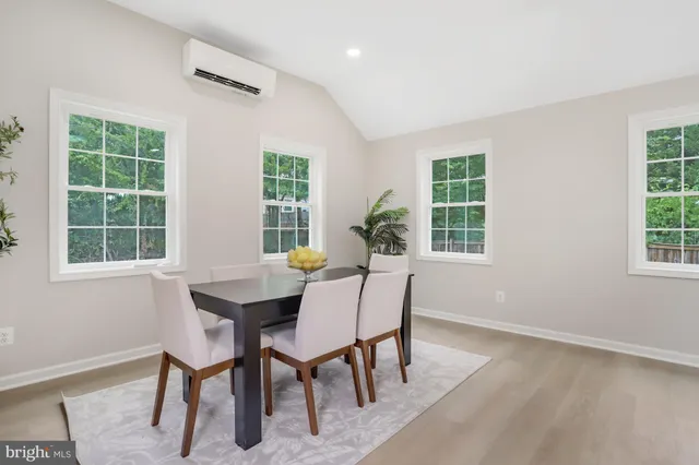 a view of a dining room with furniture and windows