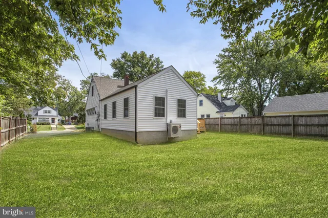 a view of a house with a yard and a garden