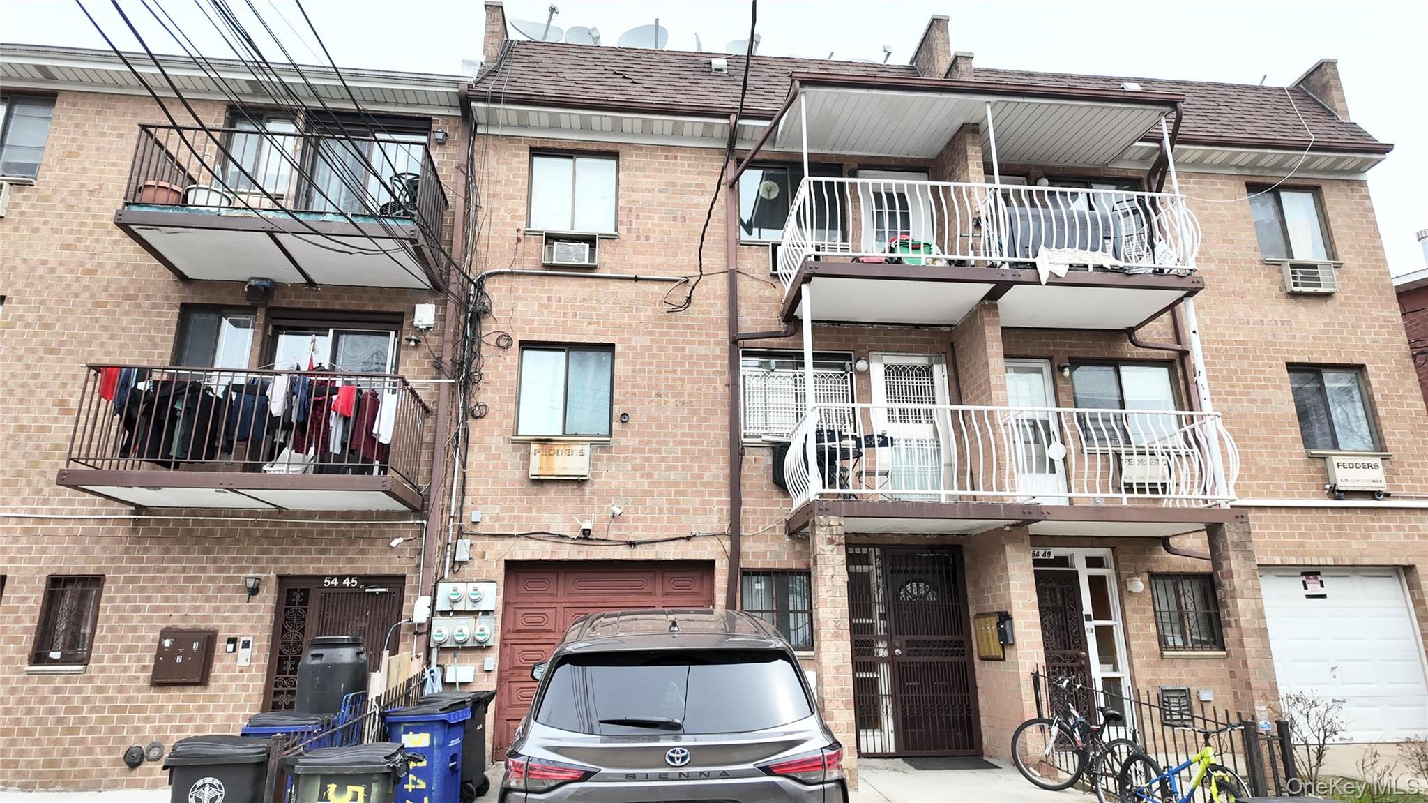 54-47 83rd Street Queens, NY 11373 - Photo 1 of 2 a front view of a houses on the street