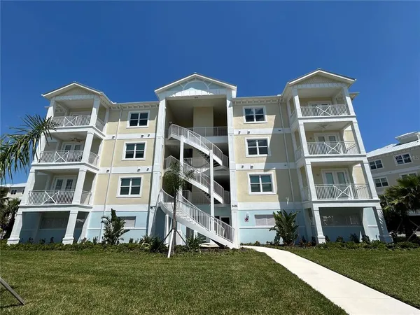a front view of multi story residential apartment building with yard