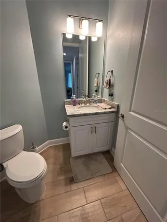 a bathroom with a sink a toilet and mirror