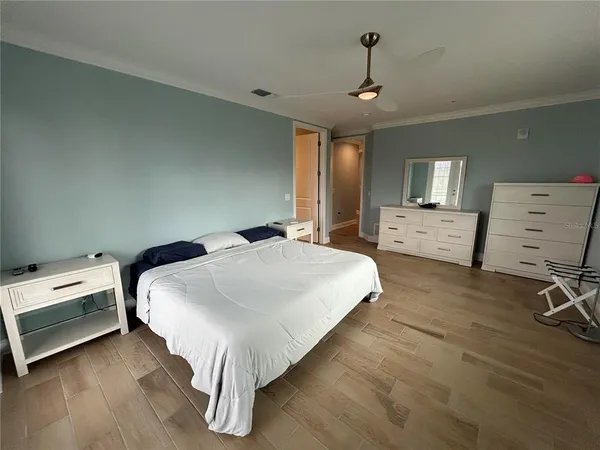 a bedroom with a bed and a chandelier