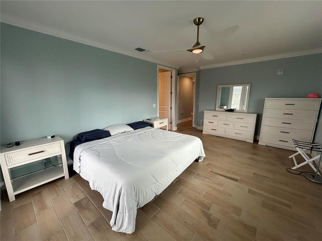 3426 79th Street Circle West, Unit 203 Bradenton, FL 34209 - Photo 12 of 30 a bedroom with a bed and a chandelier