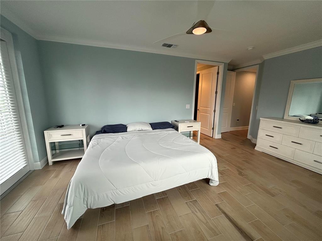 3426 79th Street Circle West, Unit 203 Bradenton, FL 34209 - Photo 13 of 30 a bedroom with a bed and a view of bathroom