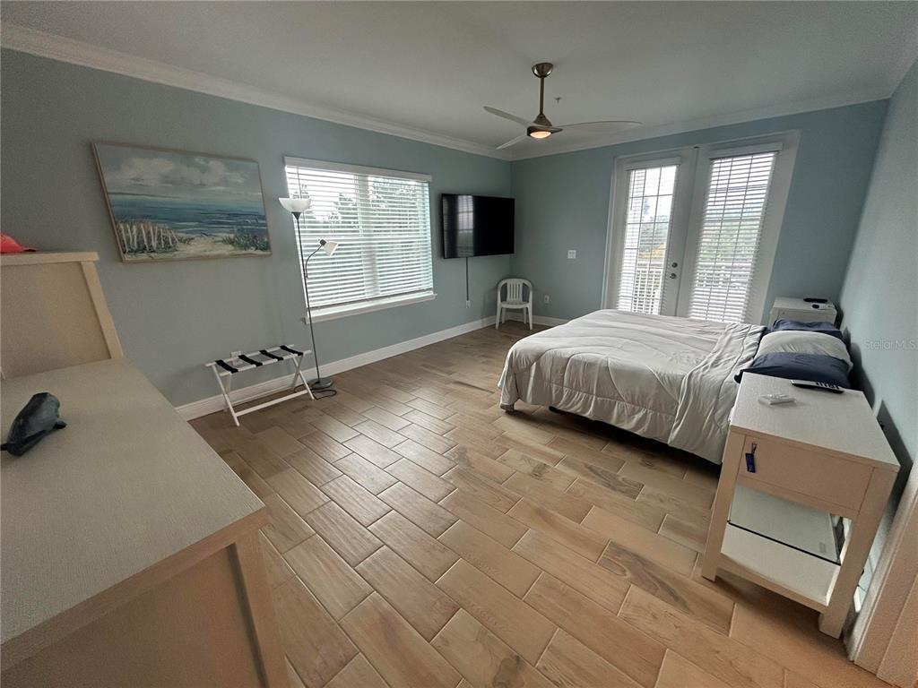 3426 79th Street Circle West, Unit 203 Bradenton, FL 34209 - Photo 14 of 30 a spacious bedroom with a bed and large windows