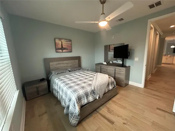 a bedroom with a bed and a flat screen tv