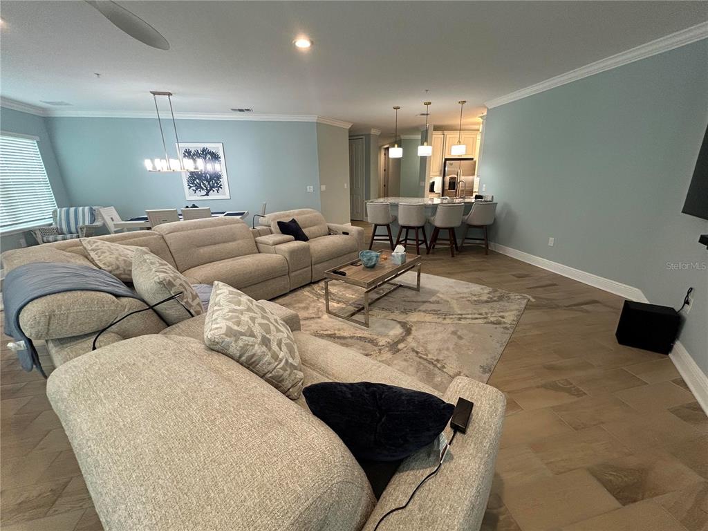 3426 79th Street Circle West, Unit 203 Bradenton, FL 34209 - Photo 8 of 30 a living room with furniture and a chandelier
