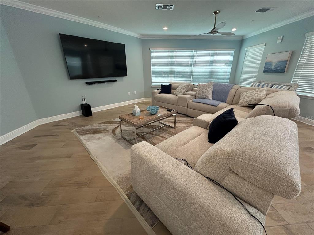 3426 79th Street Circle West, Unit 203 Bradenton, FL 34209 - Photo 9 of 30 a living room with furniture and a flat screen tv