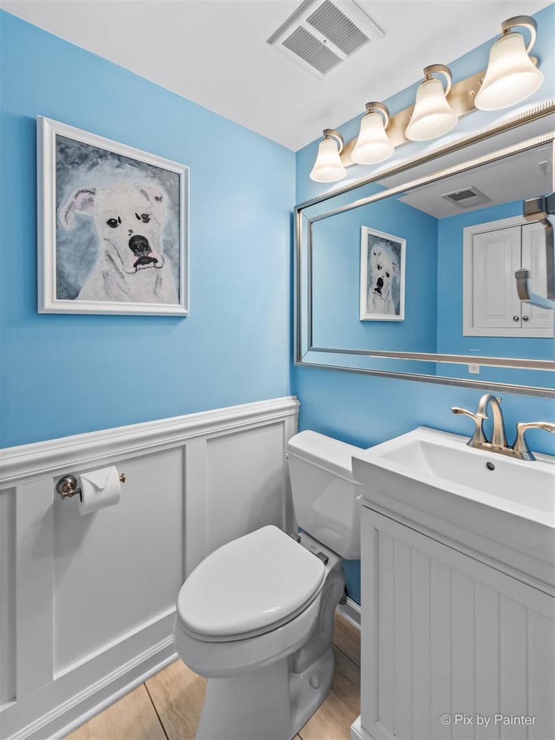 1111 South Finley Road Lombard, IL 60148 - Photo 5 of 30 a bathroom with a toilet a sink and mirror