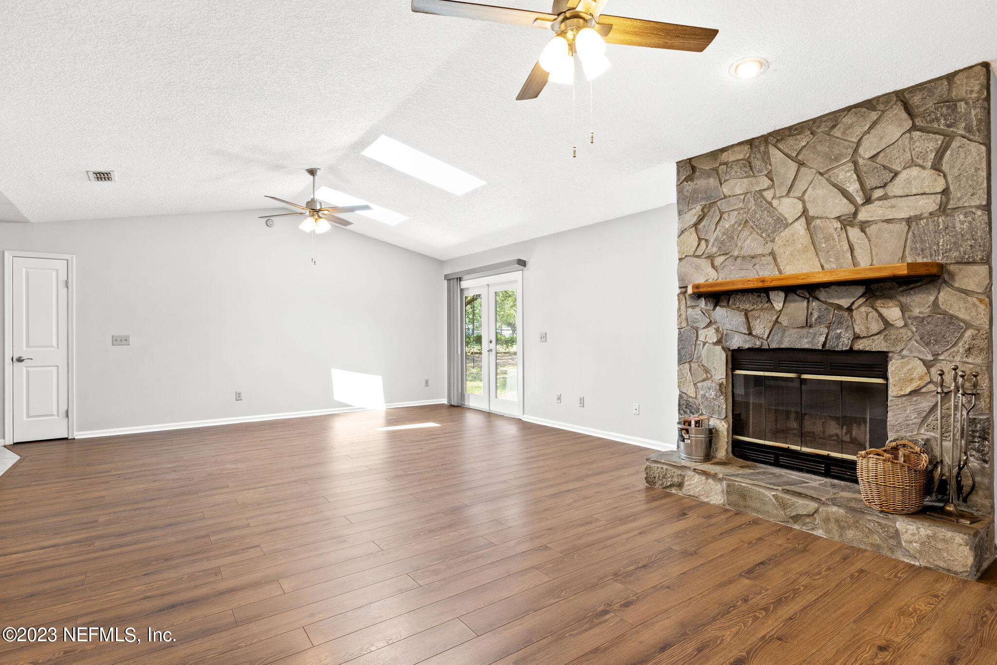 3233 Fritz Road Jacksonville, FL 32226 - Photo 12 of 43 an empty room with wooden floor fireplace and windows