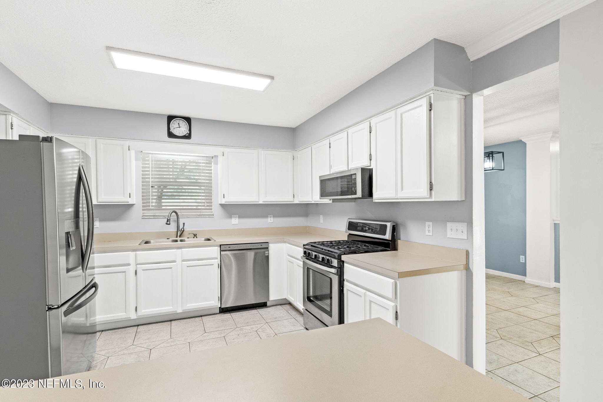 3233 Fritz Road Jacksonville, FL 32226 - Photo 17 of 43 a kitchen with white cabinets and white appliances