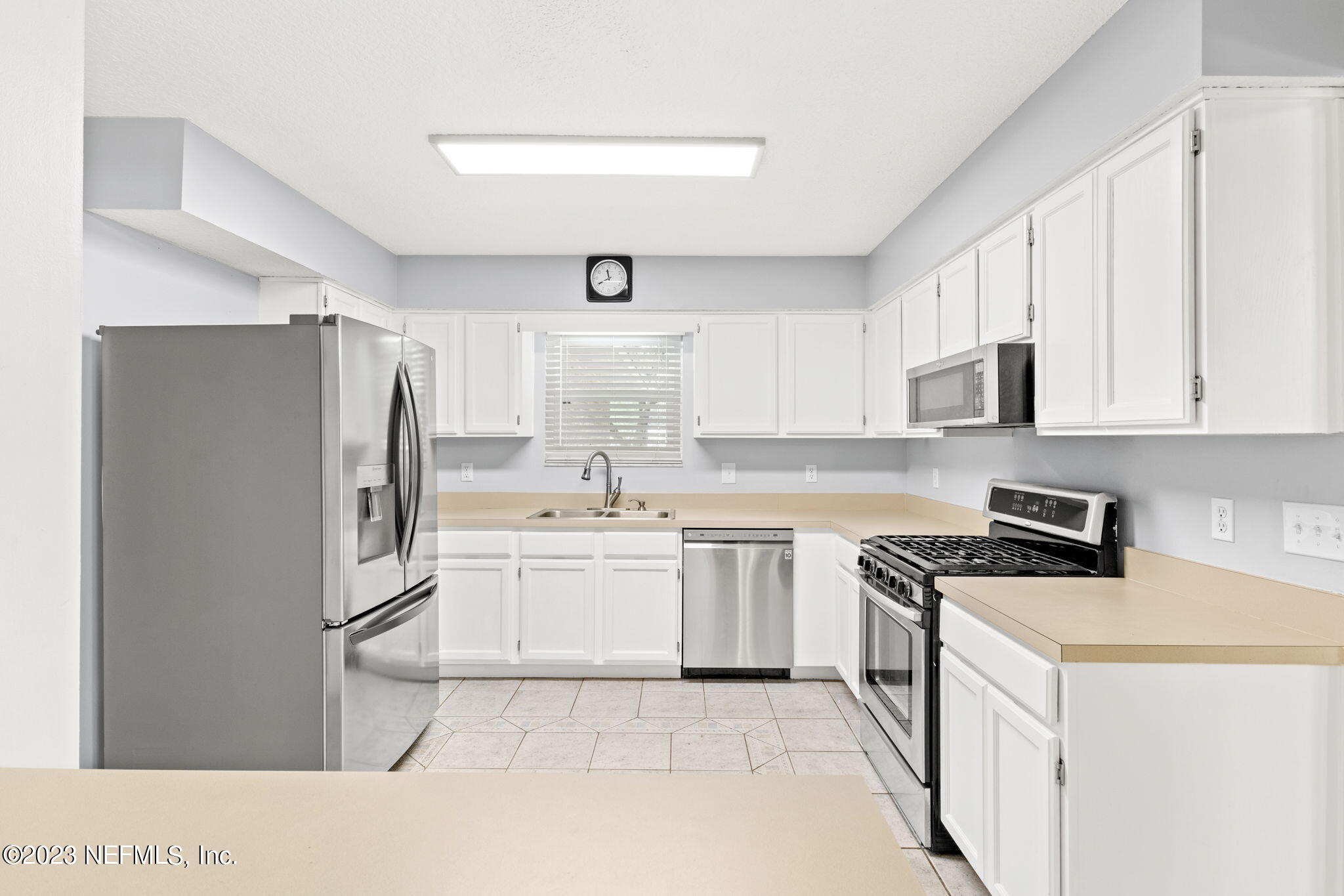 3233 Fritz Road Jacksonville, FL 32226 - Photo 18 of 43 a kitchen with white cabinets and stainless steel appliances