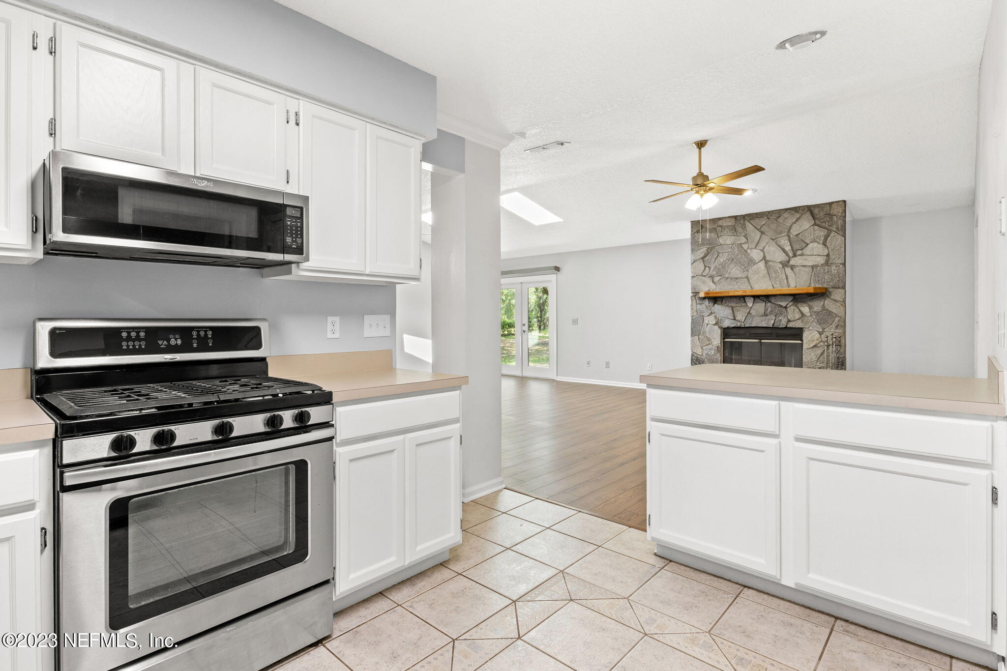 3233 Fritz Road Jacksonville, FL 32226 - Photo 21 of 43 a kitchen with cabinets stainless steel appliances and a window