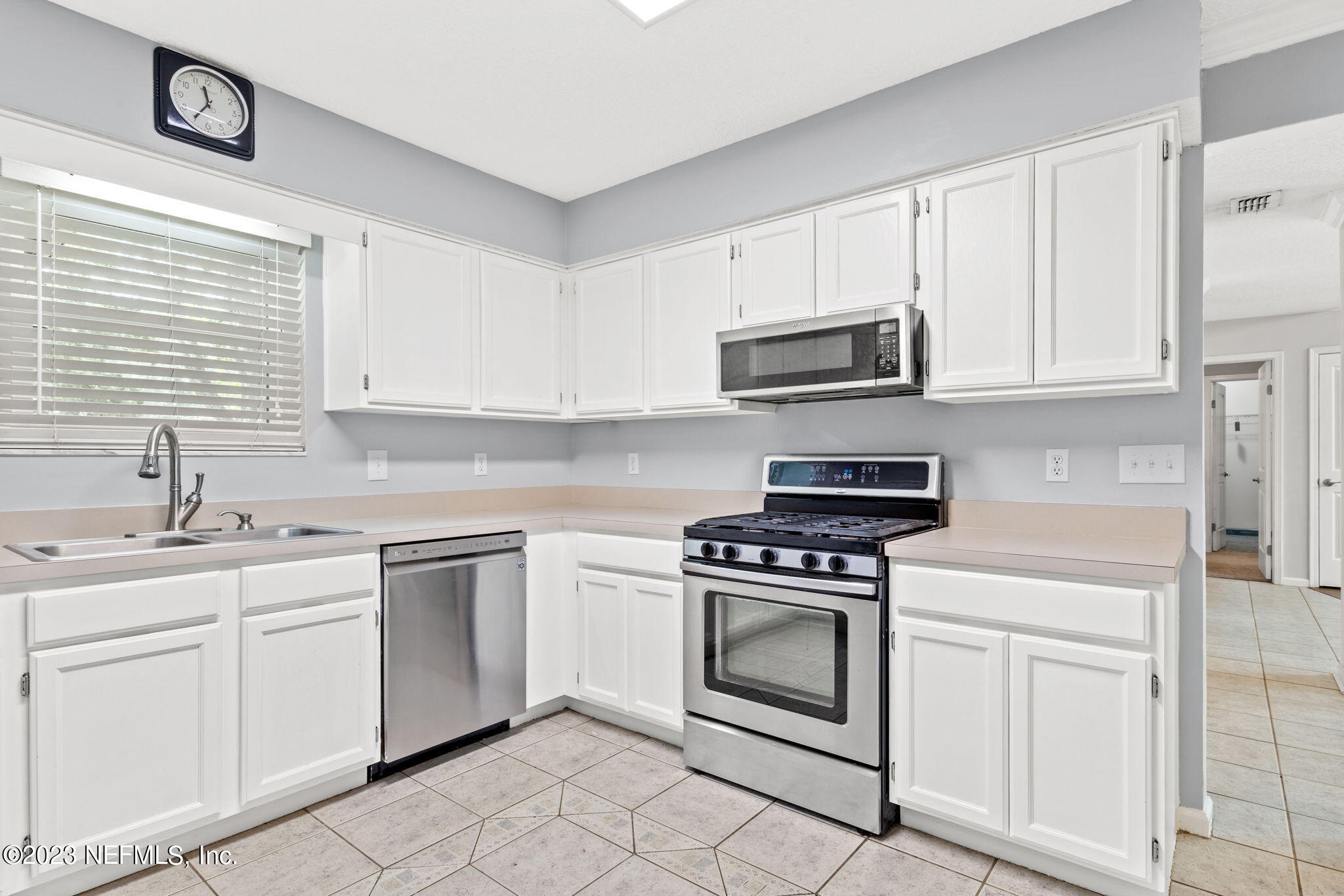 3233 Fritz Road Jacksonville, FL 32226 - Photo 22 of 43 a kitchen with white cabinets and appliances