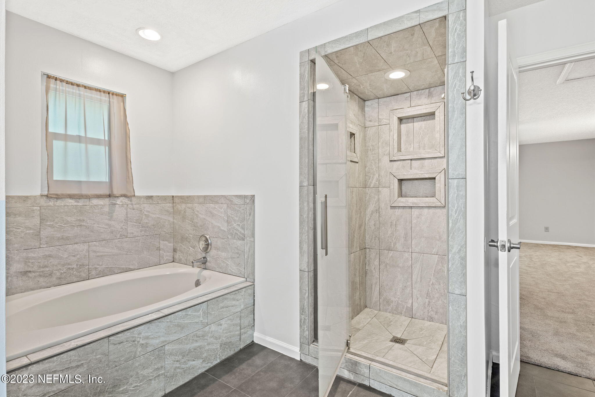 3233 Fritz Road Jacksonville, FL 32226 - Photo 26 of 43 a bathroom with a tub and shower