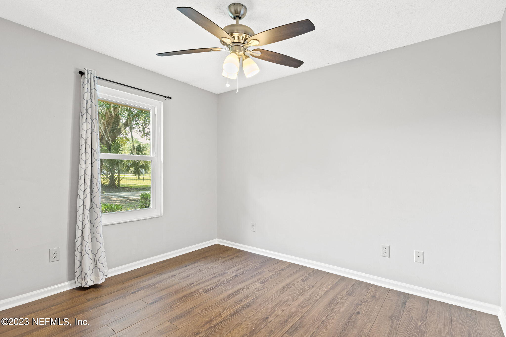 3233 Fritz Road Jacksonville, FL 32226 - Photo 30 of 43 an empty room with a window and a ceiling fan