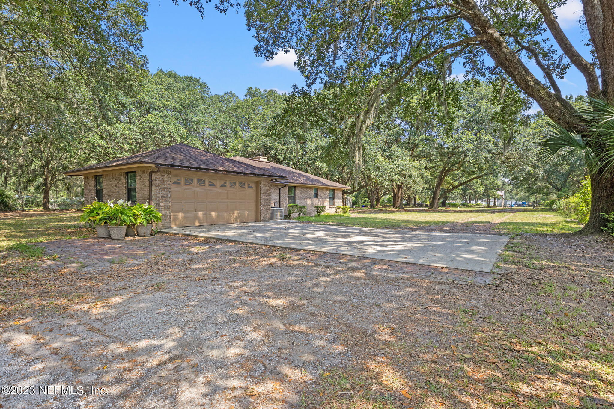 3233 Fritz Road Jacksonville, FL 32226 - Photo 33 of 43 a white house with a big yard and large trees