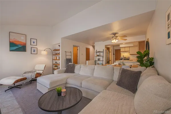 a living room with furniture and a chandelier