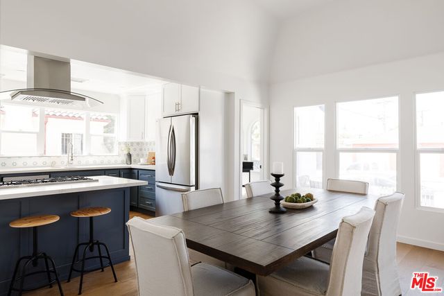a kitchen with a table chairs and refrigerator